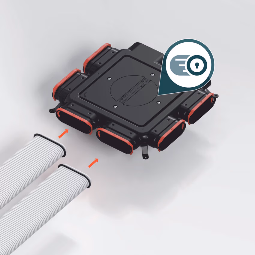 Zehnder Luftverteiler mit roten RapidLock-Clips und zwei Flachovalrohren; Pfeile zeigen die Einsteckrichtung.