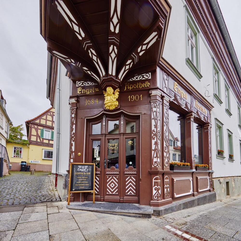 Der Bad Homburger Baumeister Louis Jacobi hat vor über 150 Jahren das heute noch erlebbare Ambiente der alten Engel Apotheke entworfen. Heute glänzt der ehemalige Jacobi-Bau als ein multifunktionales Wohn- und Geschäftshaus, wobei aus der alten Engel Apotheke nun eine gleichnamige, hippe Coffee-Bar geworden ist.